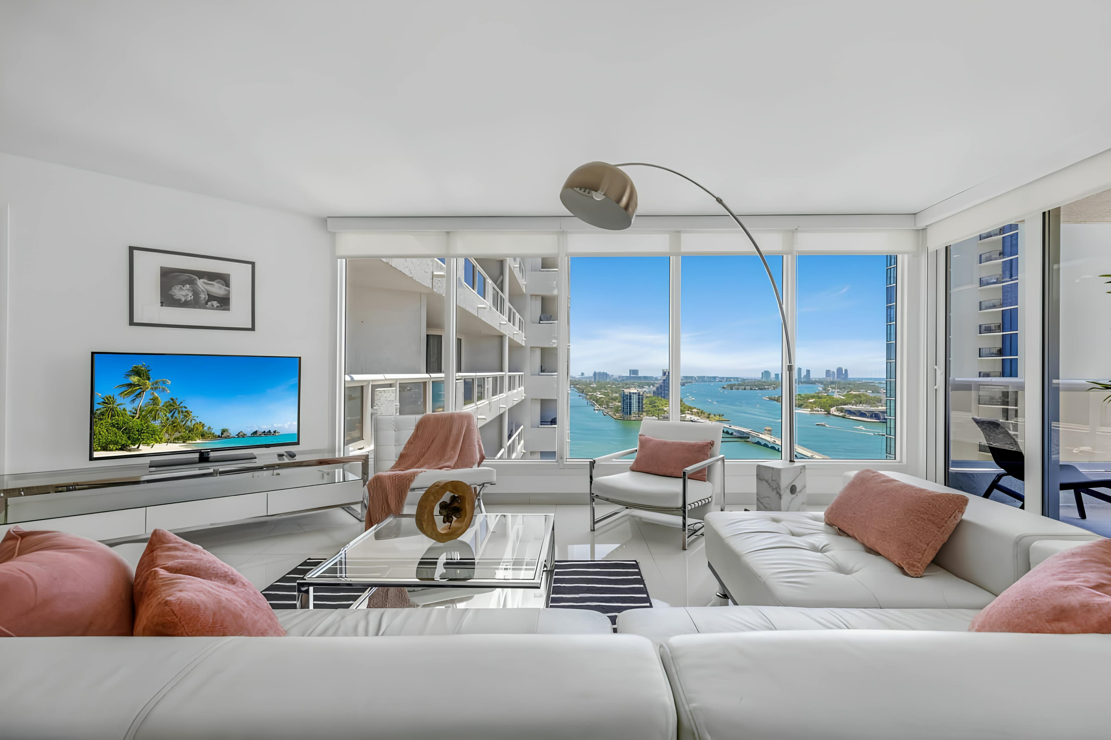 Modern Miami waterfront living room with floor-to-ceiling windows and bay views
